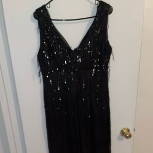 Long black shimmer dress with lots of detailing.